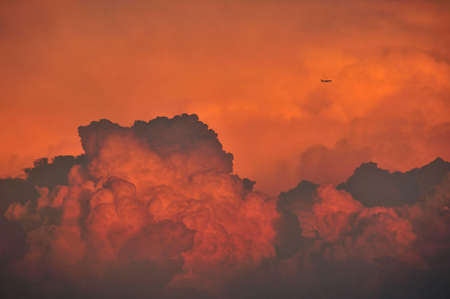 An image of an airplane flying through a cloud casting