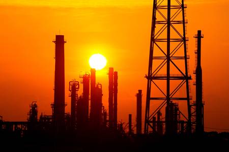 Silhouette oil refinery at sunrise 