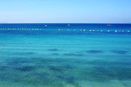 cloudy blue sky leaving for horizon above a blue surface of the sea 