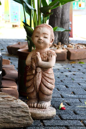 Child statue in gardenの写真素材