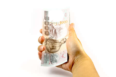 Hand holding Thailand money billsの写真素材