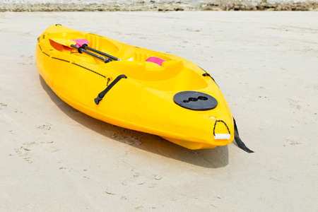 Colourful kayaks on the beach.