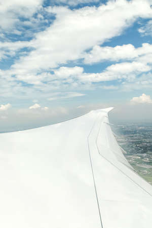 Airplane Wing in Flight from window, cloud sky., Soft focusの写真素材