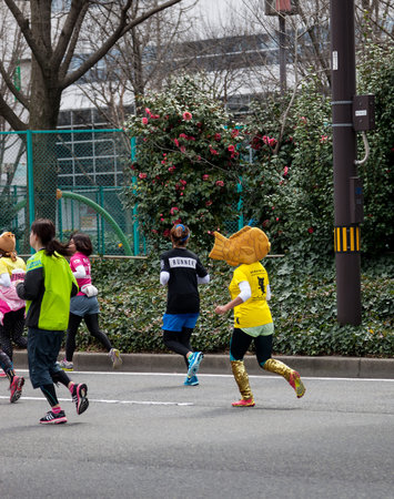 NAGOYA, JAPAN - MARCH 13, 2016: Nagoya Women's Marathon 2016. 
Women's running in the downtown. 
Course Start and finish at Nagoya Dome Distance 42.195km. Nagoya city Japan.のeditorial素材