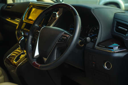 Luxury car interior. Steering wheel, shift lever and dashboard.the inside of the carの写真素材