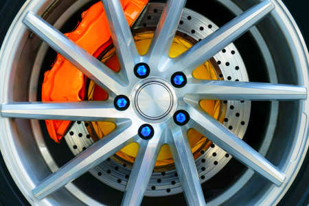 The brake system of a sport car,Car wheel - Close up of rims from a sports car , Part of modern new wheel car with disk brake padの写真素材