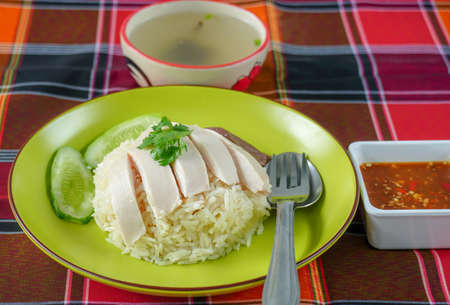 Chicken Rice on Green Plate , Chicken soup and spicy sauce on table clothの写真素材