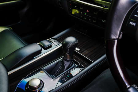 The black leather interior of a luxury . Center console with brushed nickel shift knob,の写真素材