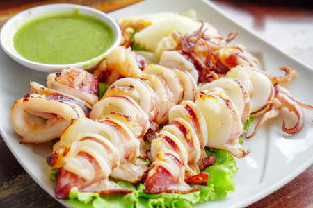 Thai Food,Slice of Grilled squid with Thai seafood sauce.の写真素材