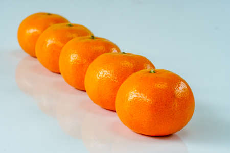 Stack of 5 navel oranges isolated on white background.One rowの写真素材