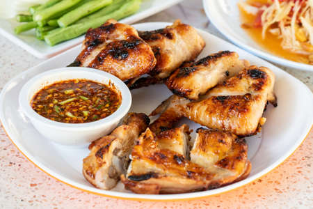 Grilled Chicken and Spicy Sauce on a white plateの写真素材