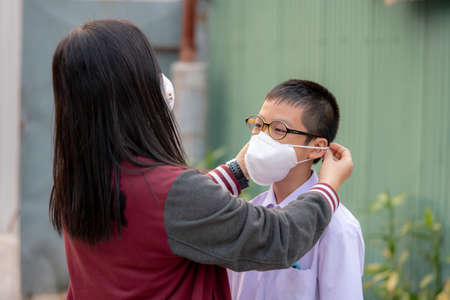 Mather and son with dust protection mask ( Safety Mask )on the streetの写真素材