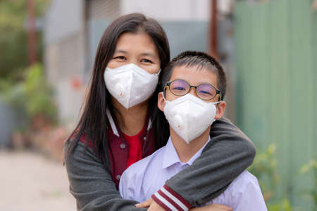 Mather and son with dust protection mask ( Safety Mask )on the streetの写真素材