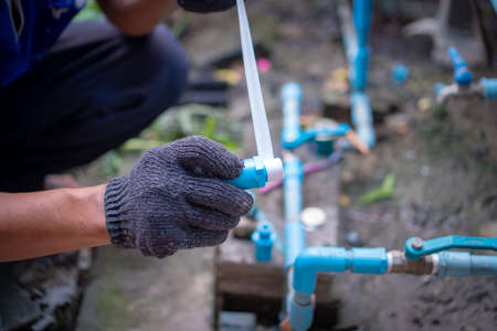 Plumber welded plastic pipes ,Plumber handâs repairing water PVC pipesの写真素材