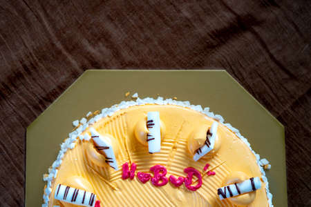 White chocolate on orange cake with pink heart shape