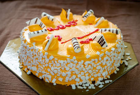 White chocolate on orange cake with pink heart shape