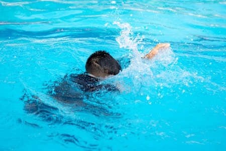 The boys are playing in the pool during the summer..
The boy is drowningの写真素材