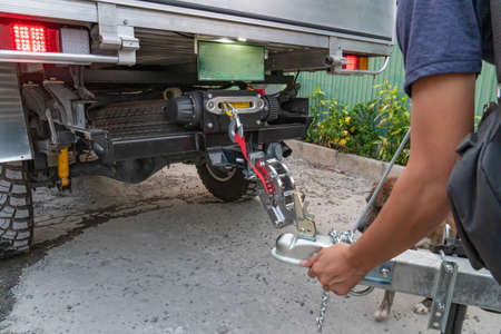Technician is installing aluminum boat head,Aluminum plated boat trailer hitch isolated