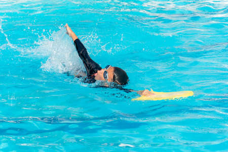 Boys are training swimming in the summer ,Close up of young boy swimming in poolの写真素材