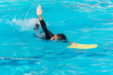 Boys are training swimming in the summer ,Close up of young boy swimming in poolの写真素材