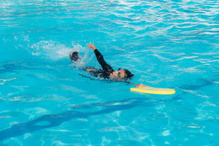 Boys are training swimming in the summer ,Close up of young boy swimming in poolの写真素材