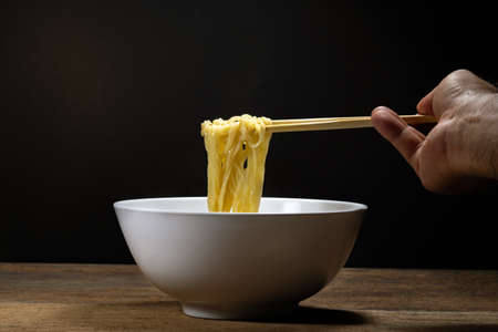 Egg noodle soup with red roast pork ,noodle on wooden backgroundの写真素材