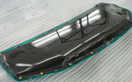 Auto mechanic is making car parts from carbon., The hood (front bonnet ) is made of carbon.の写真素材