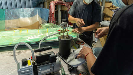 Auto mechanic is making car parts from carbon., The hood (front bonnet ) is made of carbon.