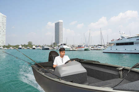 Fishermen are driving fishing boats in the sea.の写真素材