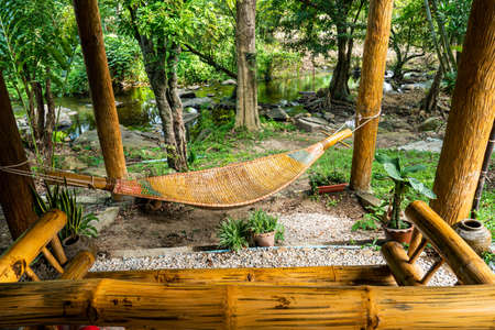 Crib is made of wood tied to the tree ,Wooden cradle bambooの写真素材
