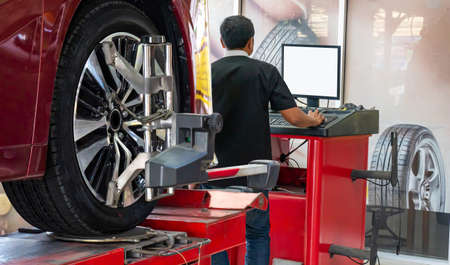 Wheel alignment ,Car on stand with sensors on wheels for wheels alignment camber check in workshop of Service station.の写真素材