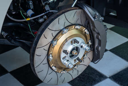 Automobile braking system. Ceramic carbon disk with perforation, ventilation and black calipers.の写真素材