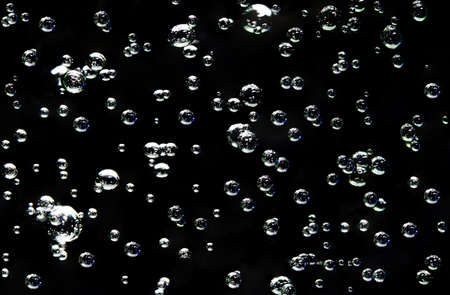 Blurred of Bubble on black background, Blurred bright soap bubbles on a dark backgroundbの写真素材