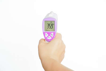 Hand holding non-contact infrared thermometer isolated on white background to measure a body temperature.Tool for detect coronavirus or covid-19の写真素材
