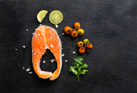 A piece of delicious fresh raw pork close-up on a cast-iron frying pan,  Raw pork steak on cast iron skilletの写真素材