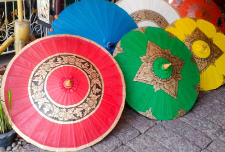 Thai style handmade colorful umbrellas background. The handmade ancient umbrella of Chiang Mai, the north of Thailand, Lanna umbrella.の写真素材