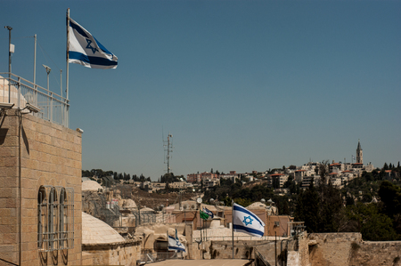 Picture over the rooftops of Jerusalem with israelian flagsの写真素材