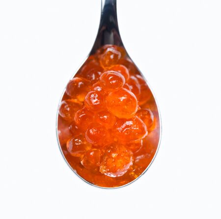 Red caviar in a spoon isolated on white close-upの写真素材