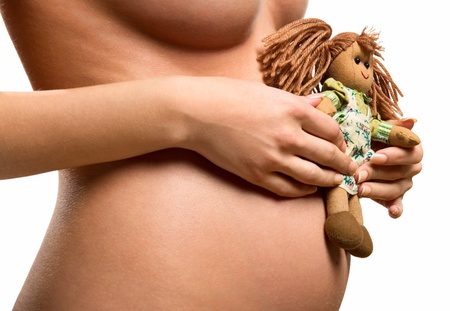 Pregnant woman holding a dollの写真素材