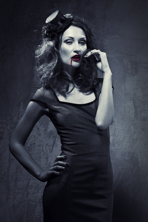 Black and white photo of seductive woman with blood on her lipsの写真素材