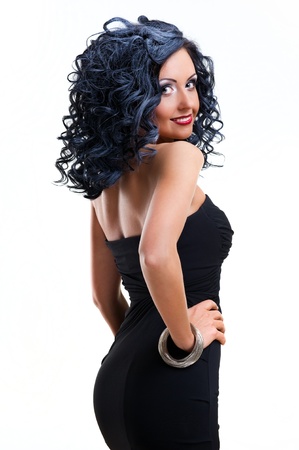 Beautiful woman wearing black dress posing over white backgroundの写真素材