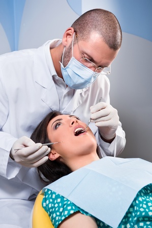 Female patient having her teeth examined by specialistの写真素材