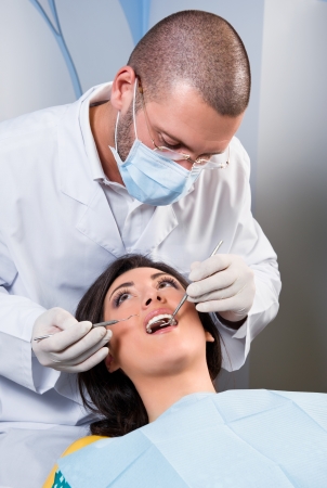 Female patient having her teeth examined by specialistの写真素材