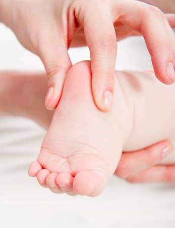 Mother massaging her babyの写真素材