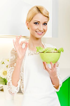 Portrait of a beautiful young woman eating vegetable salad. Dieting Concept. Vegetarian foodの写真素材