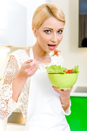 Portrait of a beautiful young woman eating vegetable salad  Dieting Concept  Vegetarian foodの写真素材