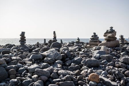 Art of stone balance, piles of stones on the beach. Tenerife, Canary Islands. Spain