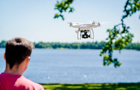 Quadrocopter with photo camera flying outdoors