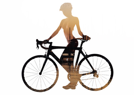 Double exposure of a naked woman with a bicycle. Combined with a sea at sunset. Isolated on a white backgroundの写真素材