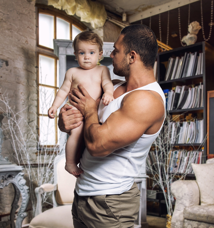 Athletic father with daughter at homeの写真素材